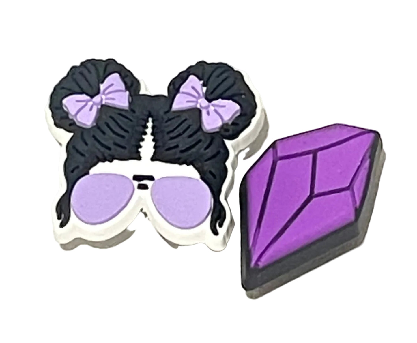 Black and purple decorative items with a gemstone on a white background