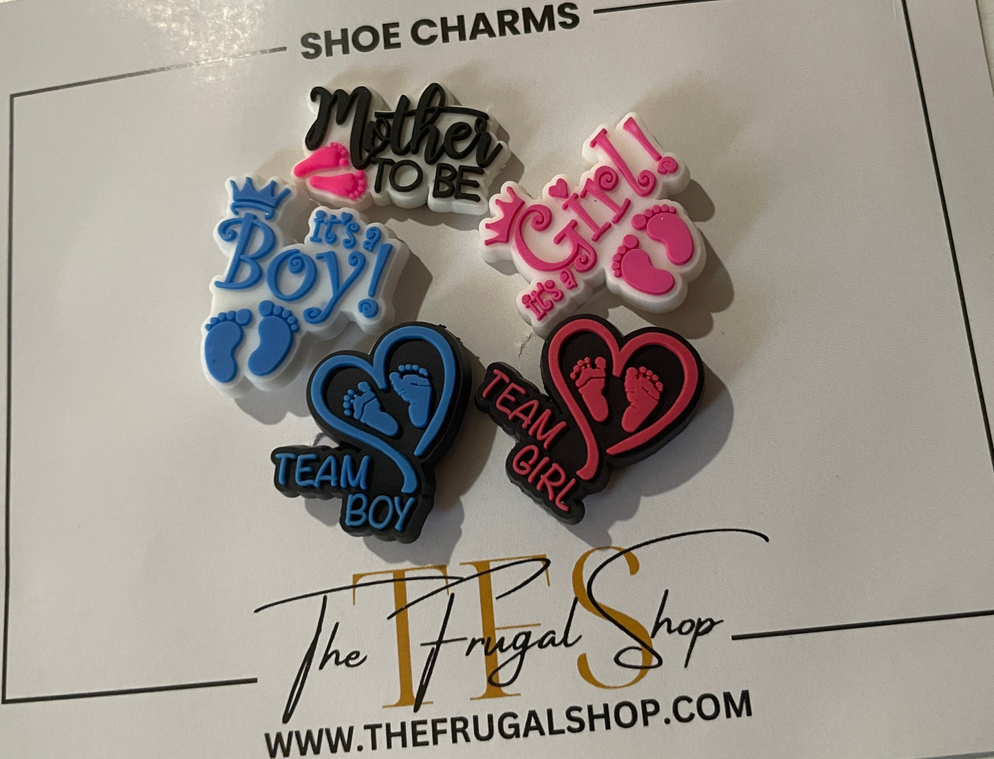 Set of shoe charms on a card from The Frugal Shop with text indicating gender choices.