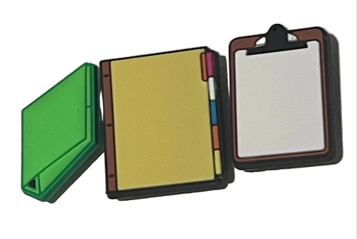 Small open notebook with colorful markers on a plain background