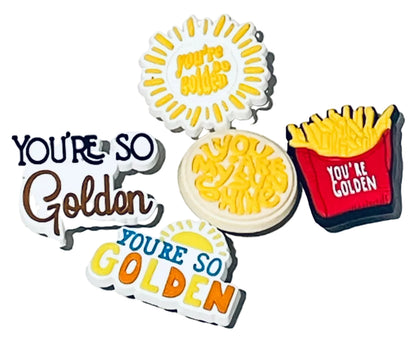 Set of 'You're So Golden' themed pins on a light gray background