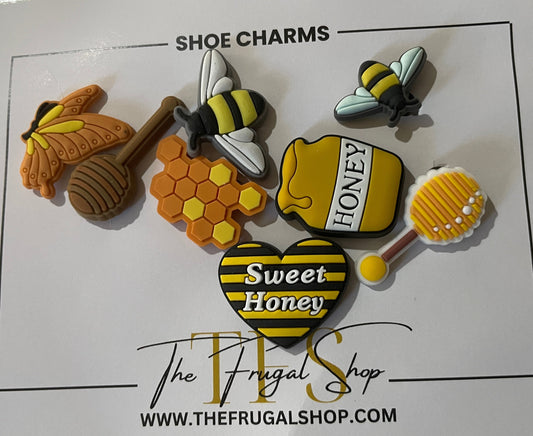 Set of shoe charms with bee and honey design on a card from The Frugal Shop.