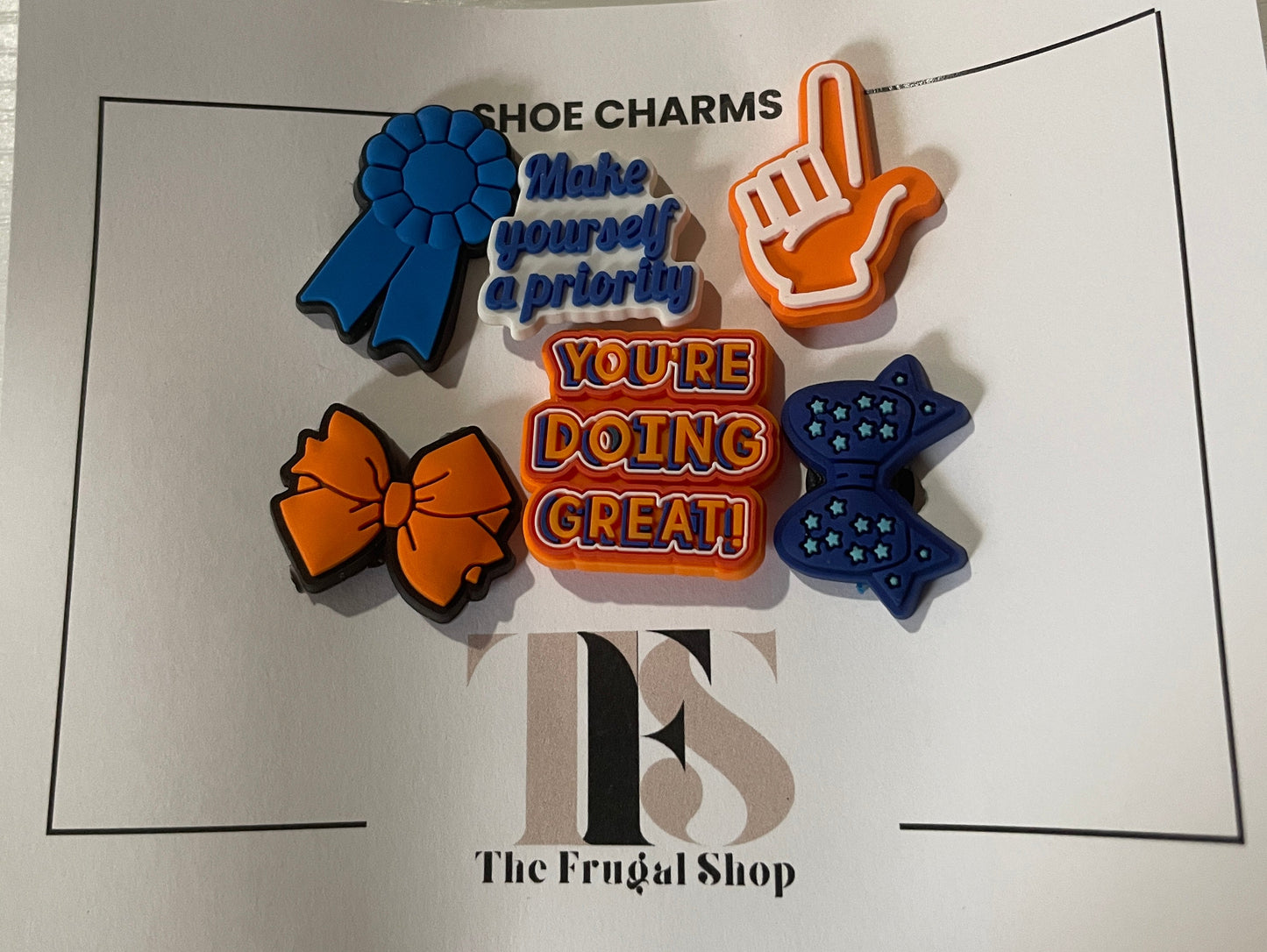 Colorful shoe charms on a card with text