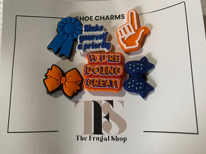 Colorful shoe charms on a card with text