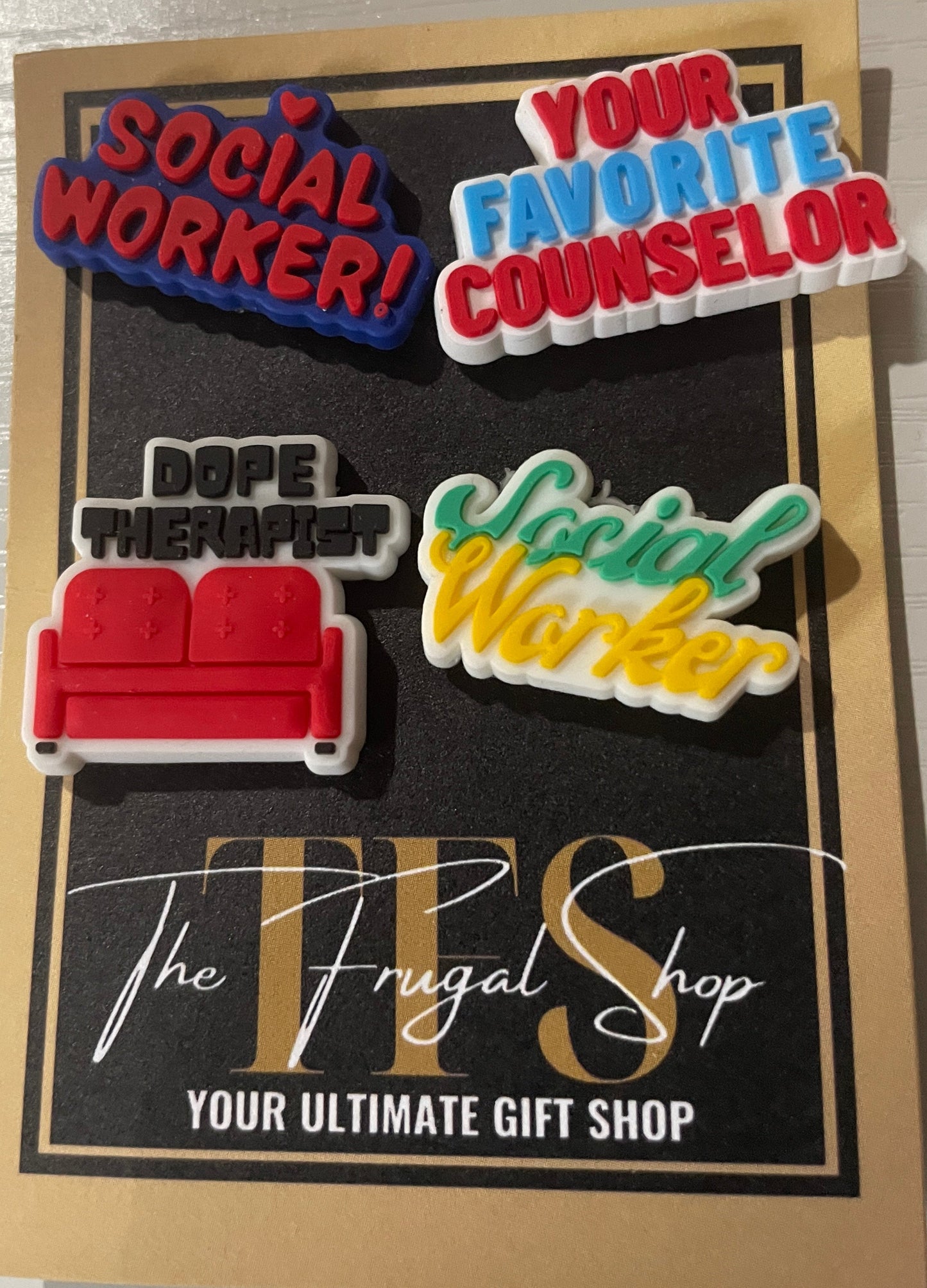 Set of colorful pins on a card with text, displayed on a white surface.