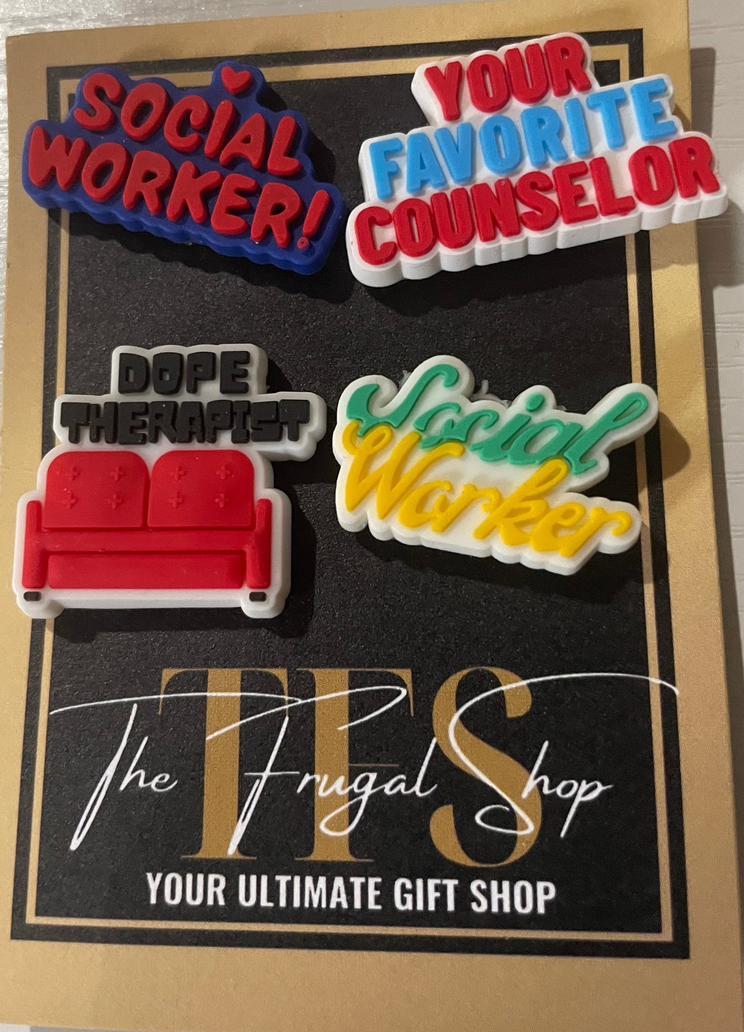 Set of colorful pins on a card with text, displayed on a white surface.