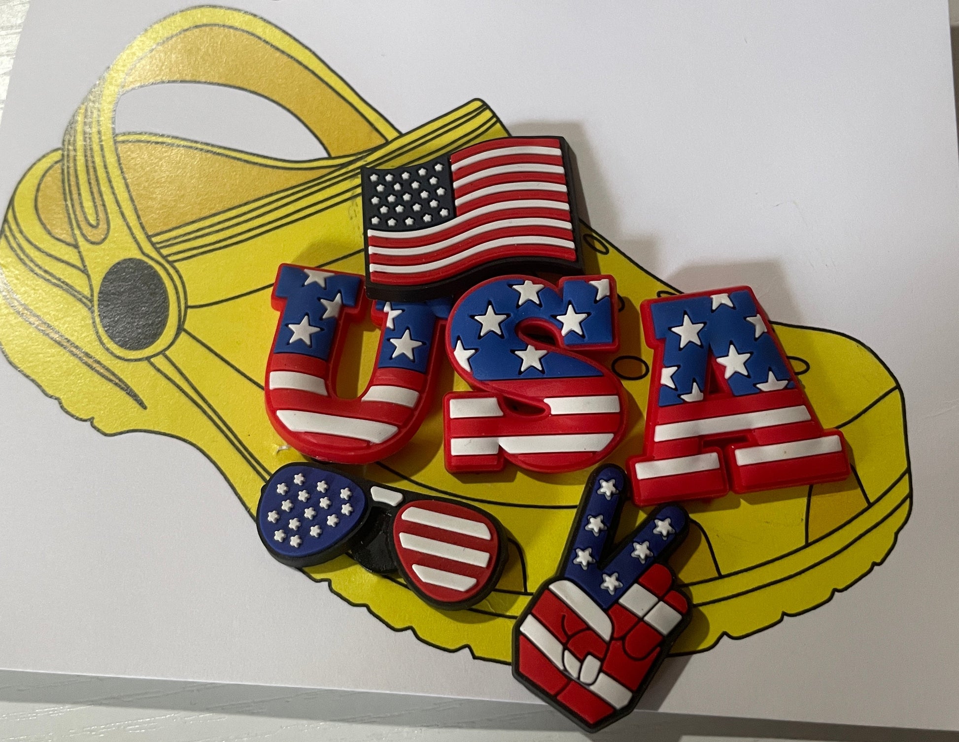 Shoe charms with American flag design on a branded card