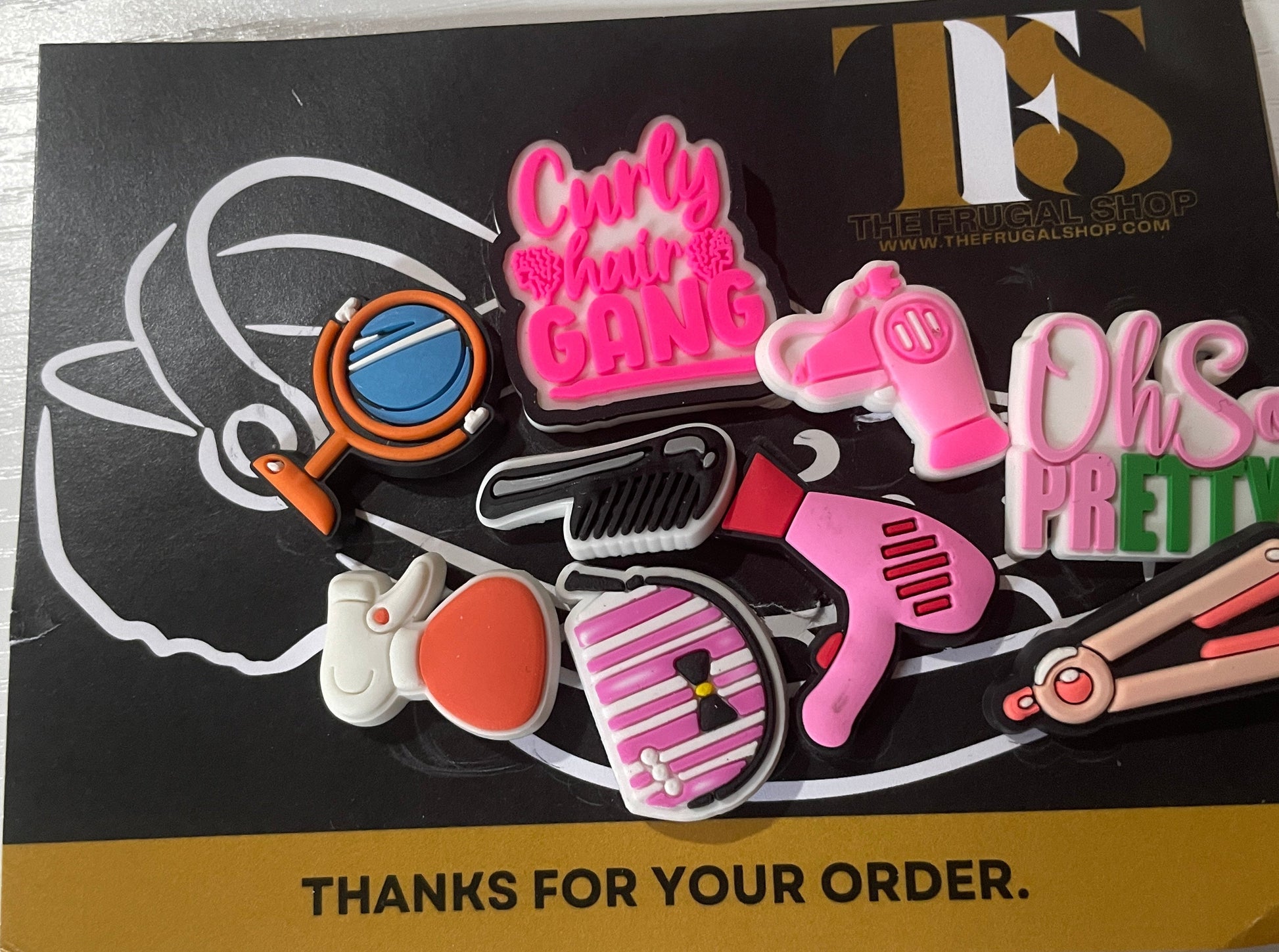 Set of colorful hair styling tools pins on a box with 'Thanks for your order' text.