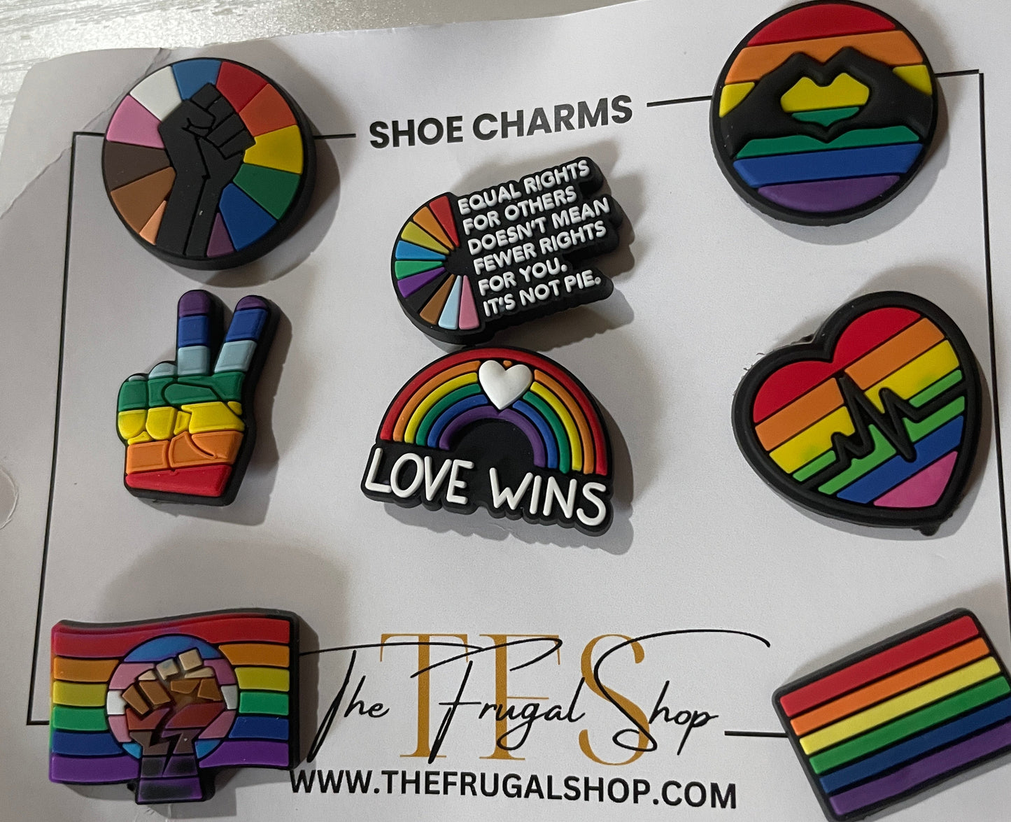 Set of rainbow-themed shoe charms on a branded card from The Frugal Shop.