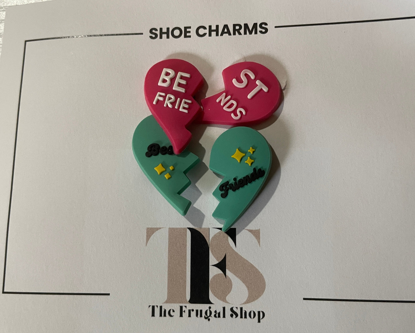 Two heart-shaped shoe charms on a card from The Frugal Shop