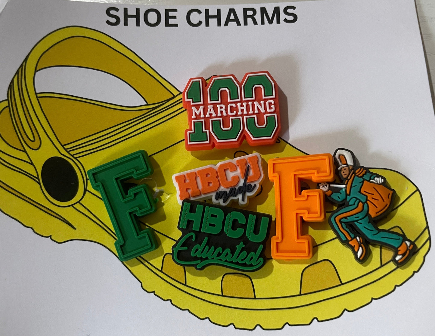 Shoe charms with colorful designs on a yellow shoe-shaped card labeled 'SHOE CHARMS'.