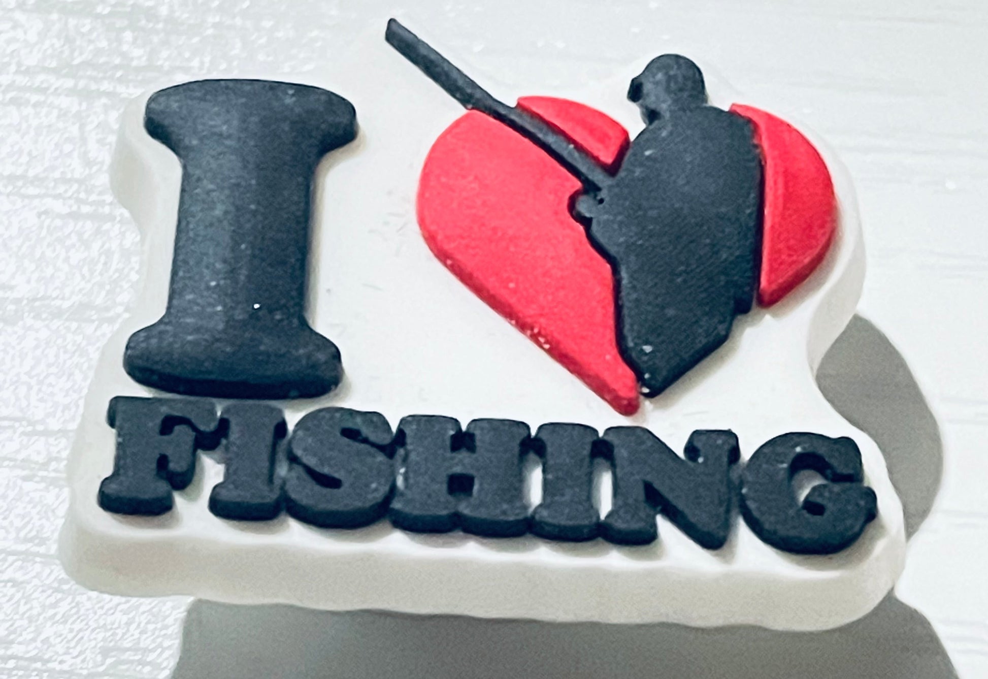 Fishing-themed cake with 'I ❤️ FISHING' text on a white background