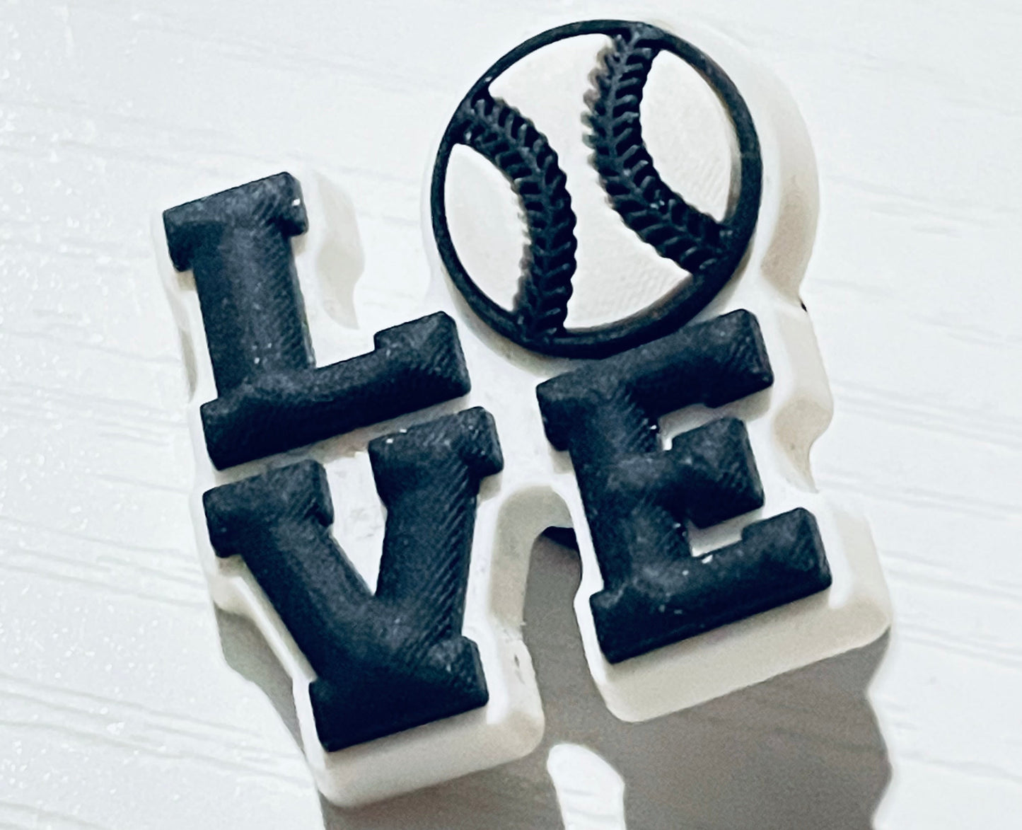 Black 'LOVE' letter beads on a white background